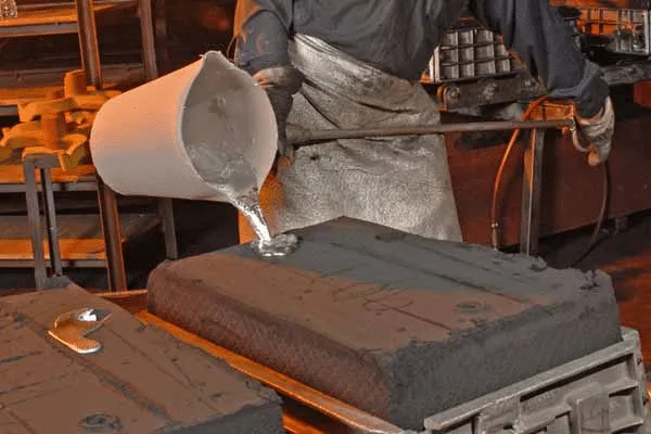 Workers are casting parts.